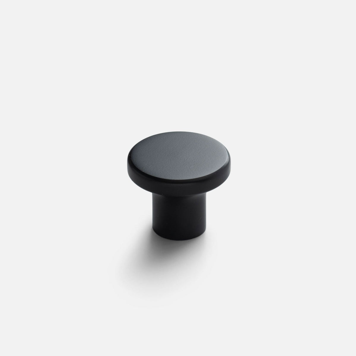 Front three-quarter view of the Roland Cabinet Knob showcasing its round black finish with a light gray background
