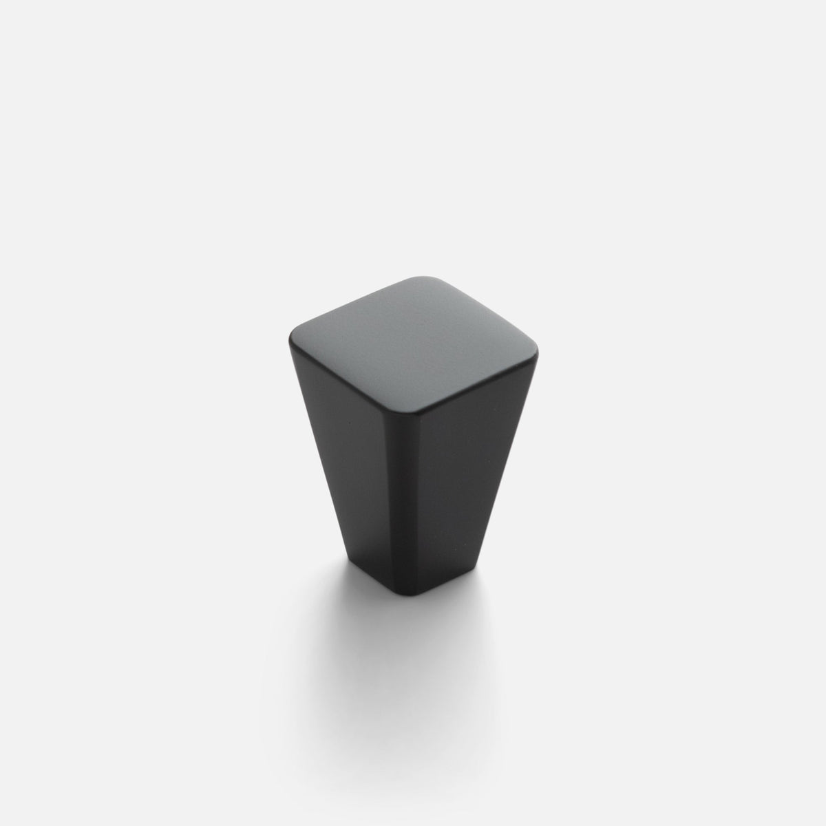 Front view of Truss Knob showcasing its faceted True Black finish and rounded square top on a white background