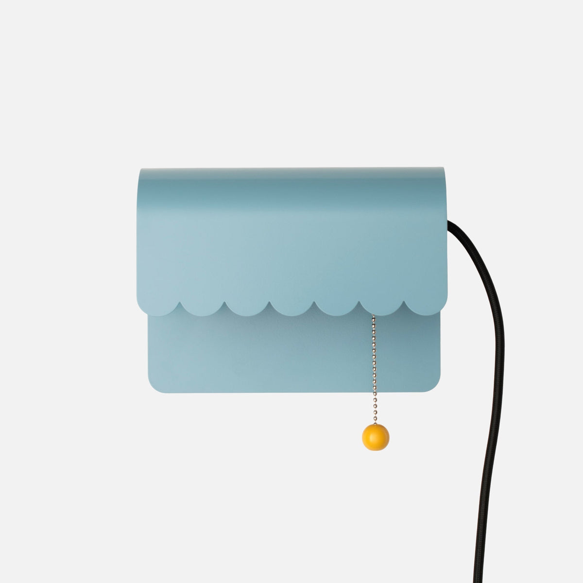 Front view of Dolores Plug-In Sconce showcasing scalloped edge, pull chain, and cord against a white background