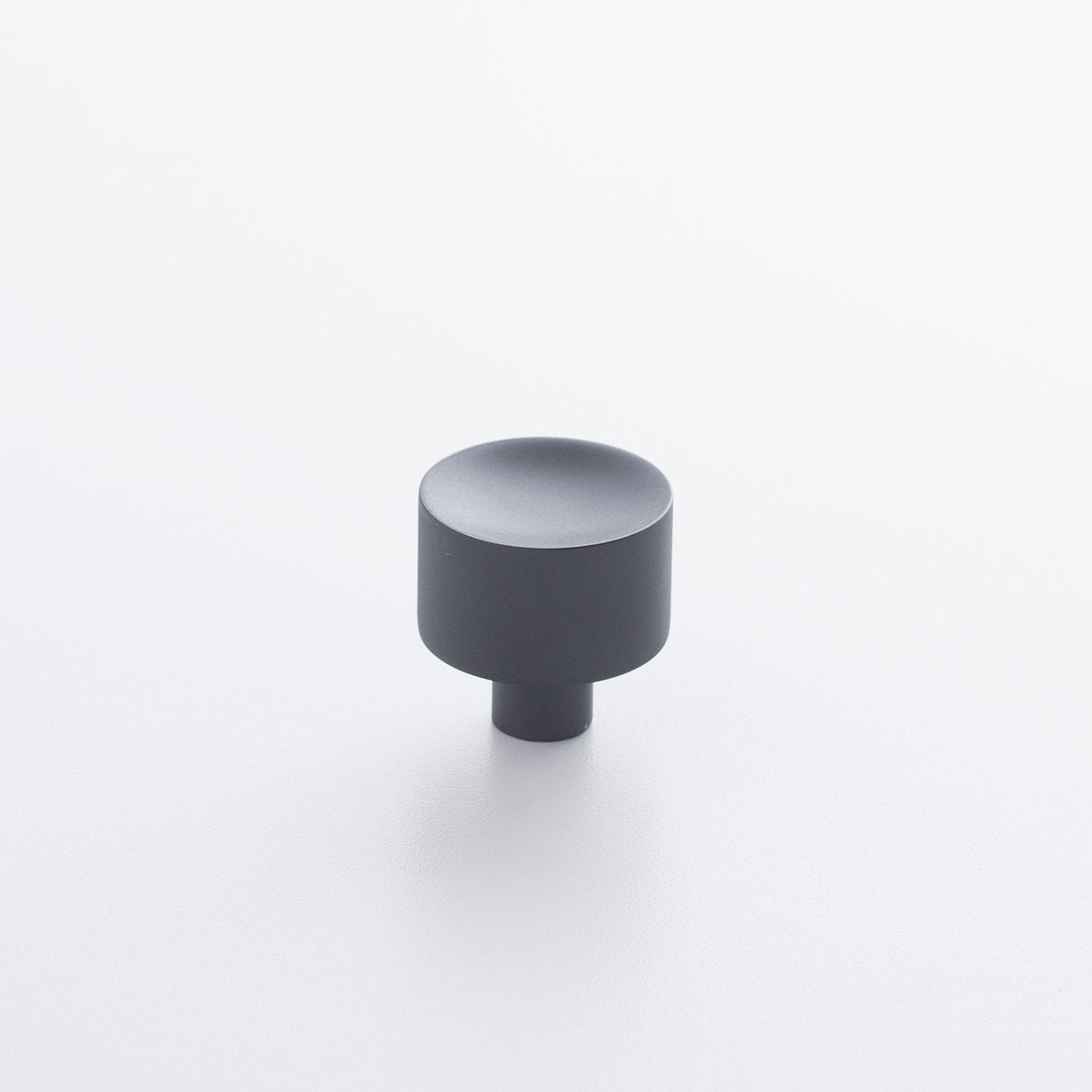 Angled view of Mid Century Knob showcasing its cylindrical shape and short base on a white background