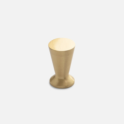 Front view of the Radcliffe Knob in natural brass, showcasing its tapered solid brass design on a light gray background