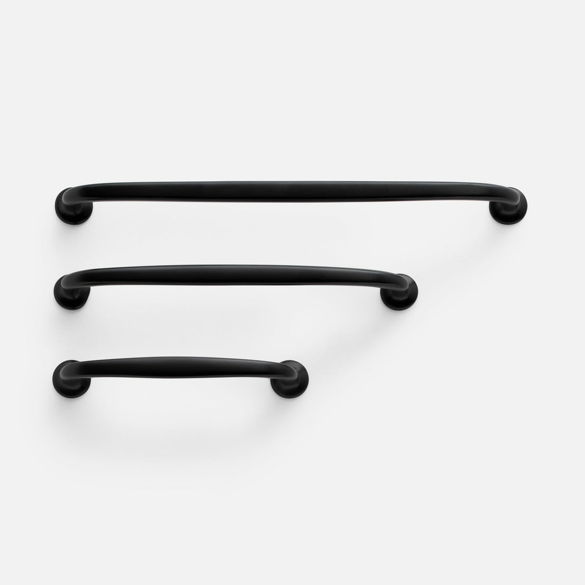 Front view of Somerset Pull in black showcasing three curved bar pulls with round mounts on a white background