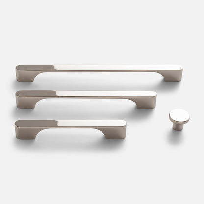 Front view of Roland Knob showcasing its round profile and polished nickel finish alongside matching cabinet pulls on a white background
