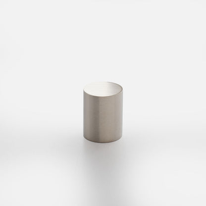 Front view of Cove Knob showcasing its cylindrical shape and brushed metal finish on a white background