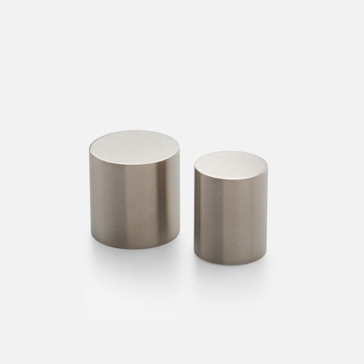 Front view of Cove Knob showcasing two cylindrical metal knobs with a brushed finish on a white background