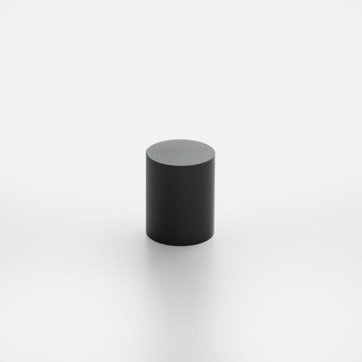 Front view of Cove Knob showcasing its black cylindrical shape against a white background