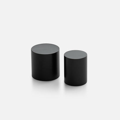 Front angled view of two black Cove Knobs showcasing cylindrical design with a light background