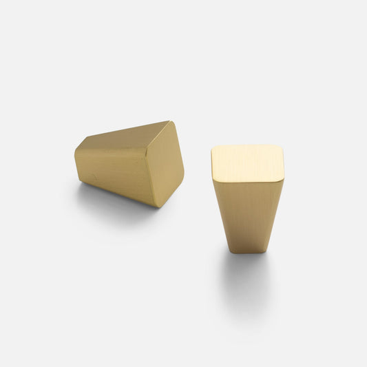 Front and side views of the Truss Knob in Natural Brass showcasing its angled geometric shape on a light gray background
