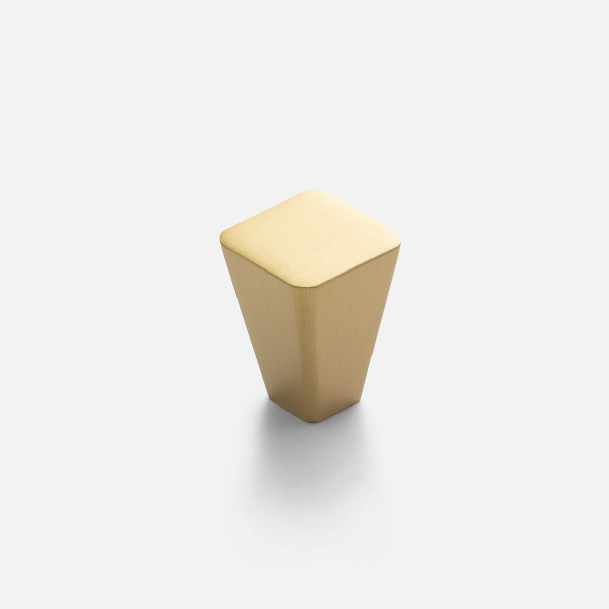 Front view of Truss Knob showcasing its tapered square shape in natural brass with a white background