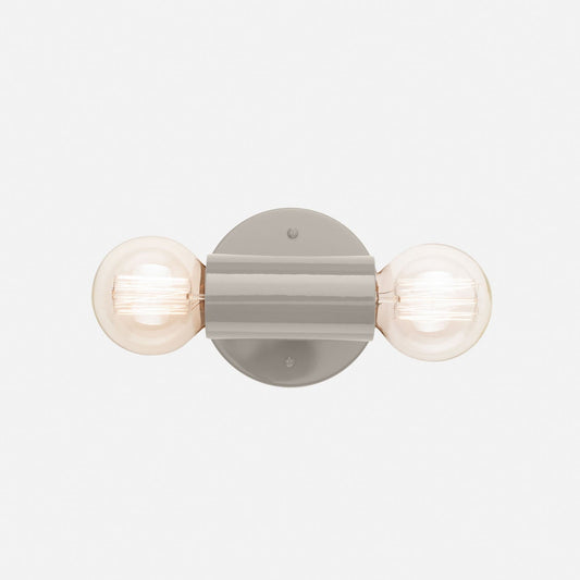 Front view of the Cylinder Double Sconce showcasing its gray gloss finish and two exposed bulbs on a white background