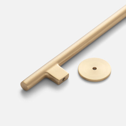 Close-up of Galley Pull showcasing its natural brass finish, sweeping curves, and optional back-plate on white
