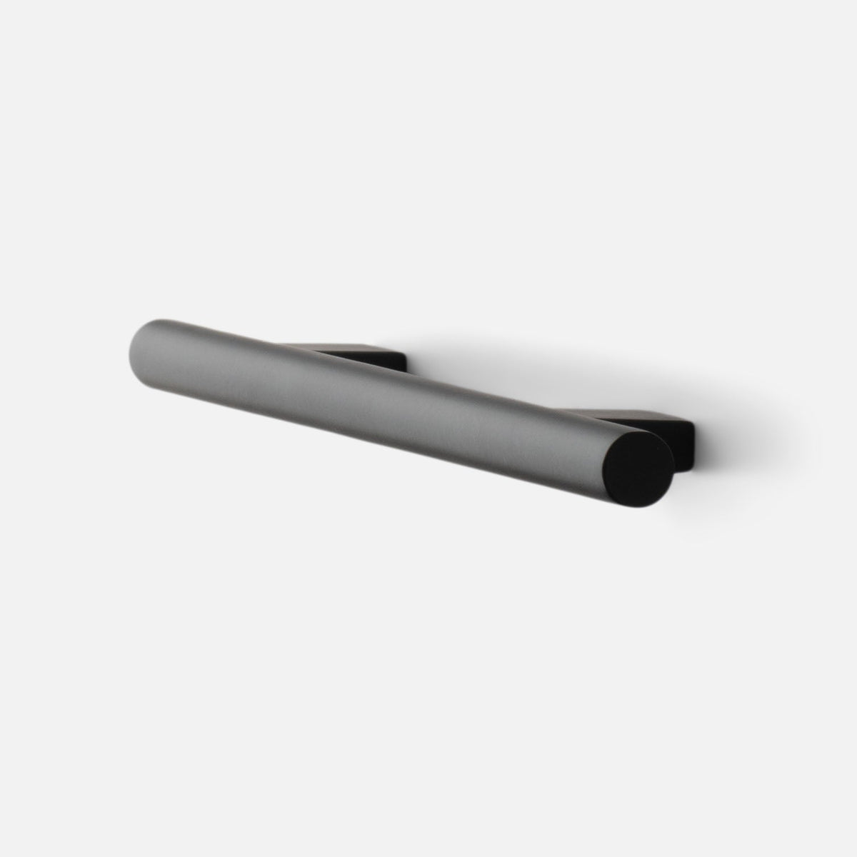 Angled view of Galley Pull showcasing its cylindrical bar and mounting bases in True Black finish on a white background
