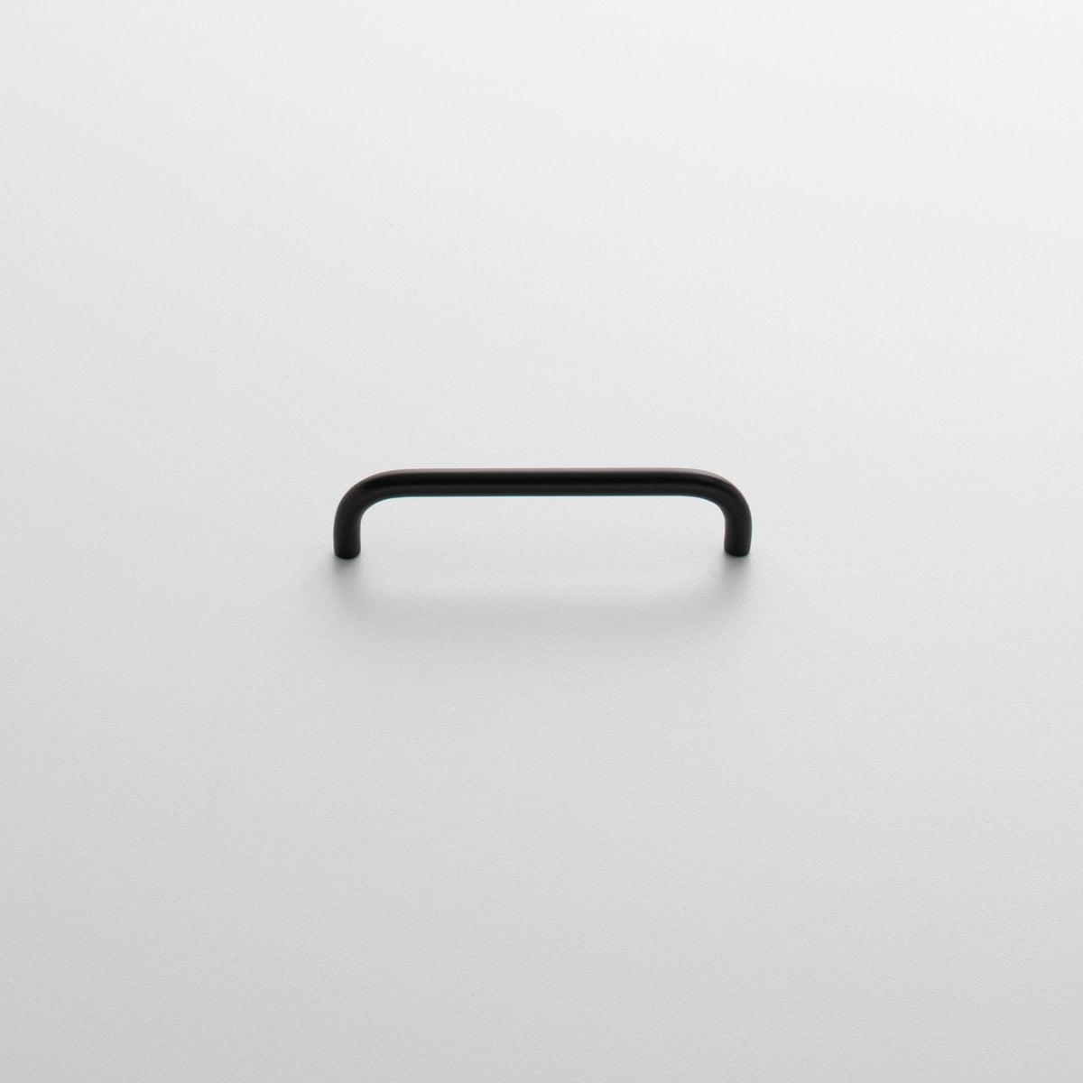 Front view of Parker Pull showcasing its rounded rectangular shape and black finish on a light background