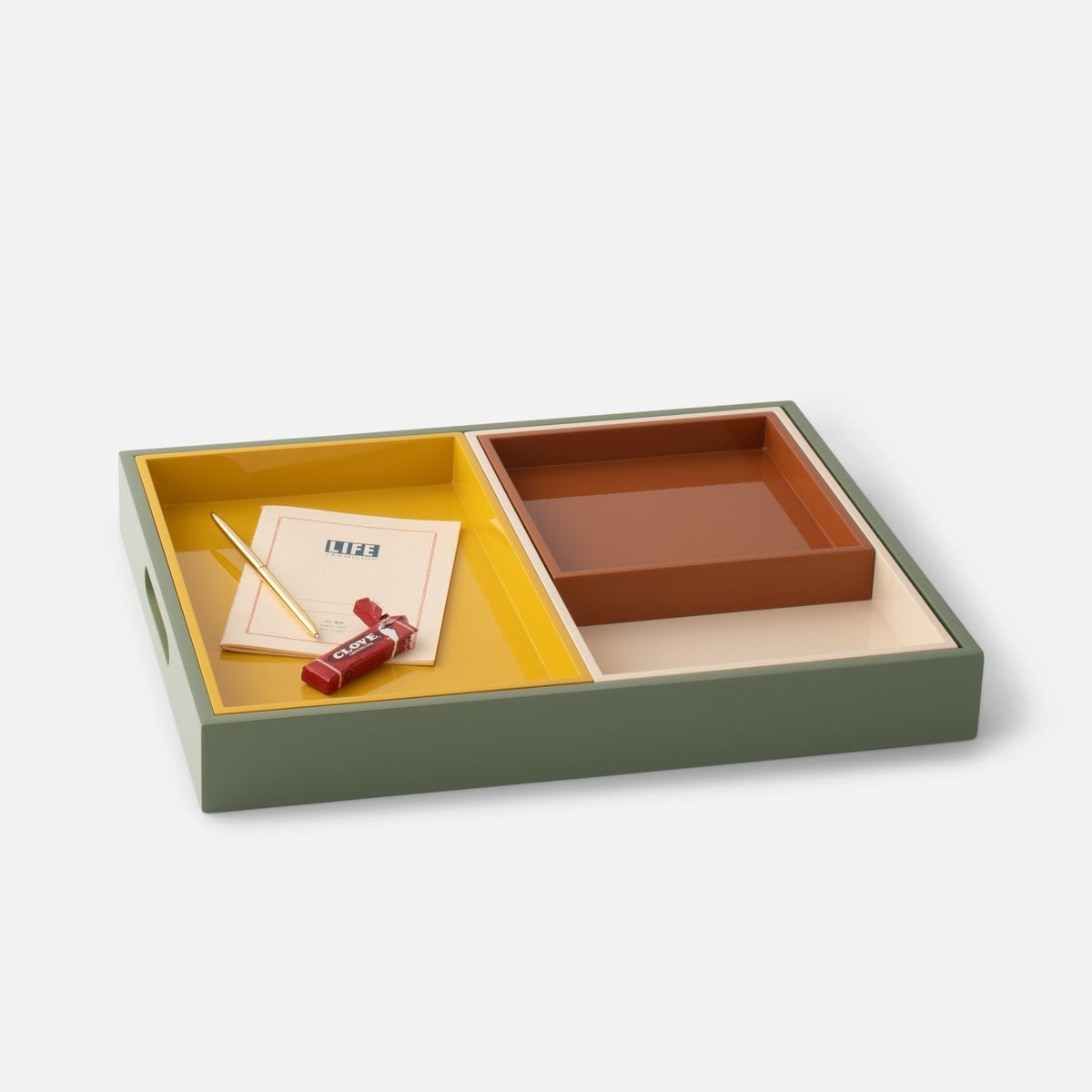 Angled view of Stacking Trays, Set of 4 showcasing muted-color lacquer finish and nesting design on white background