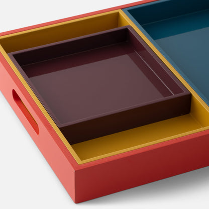 Close-up view of Stacking Trays, Set of 4 showcasing four nested lacquer-finished trays in muted colors on a white background