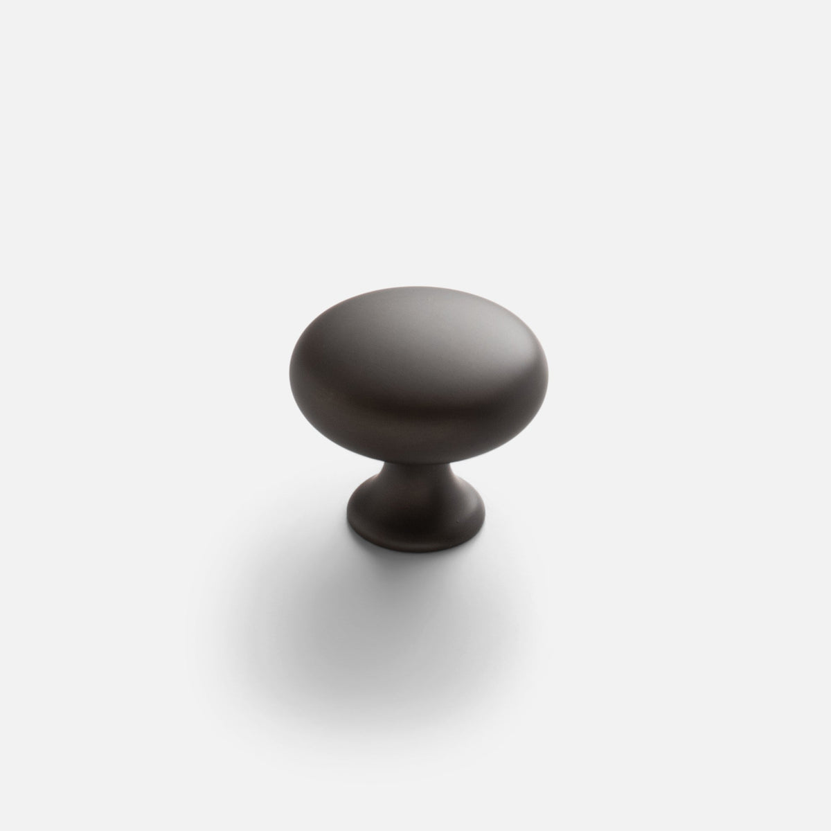 Front view of Somerset Knob showcasing its egg-shaped solid brass silhouette with a white background