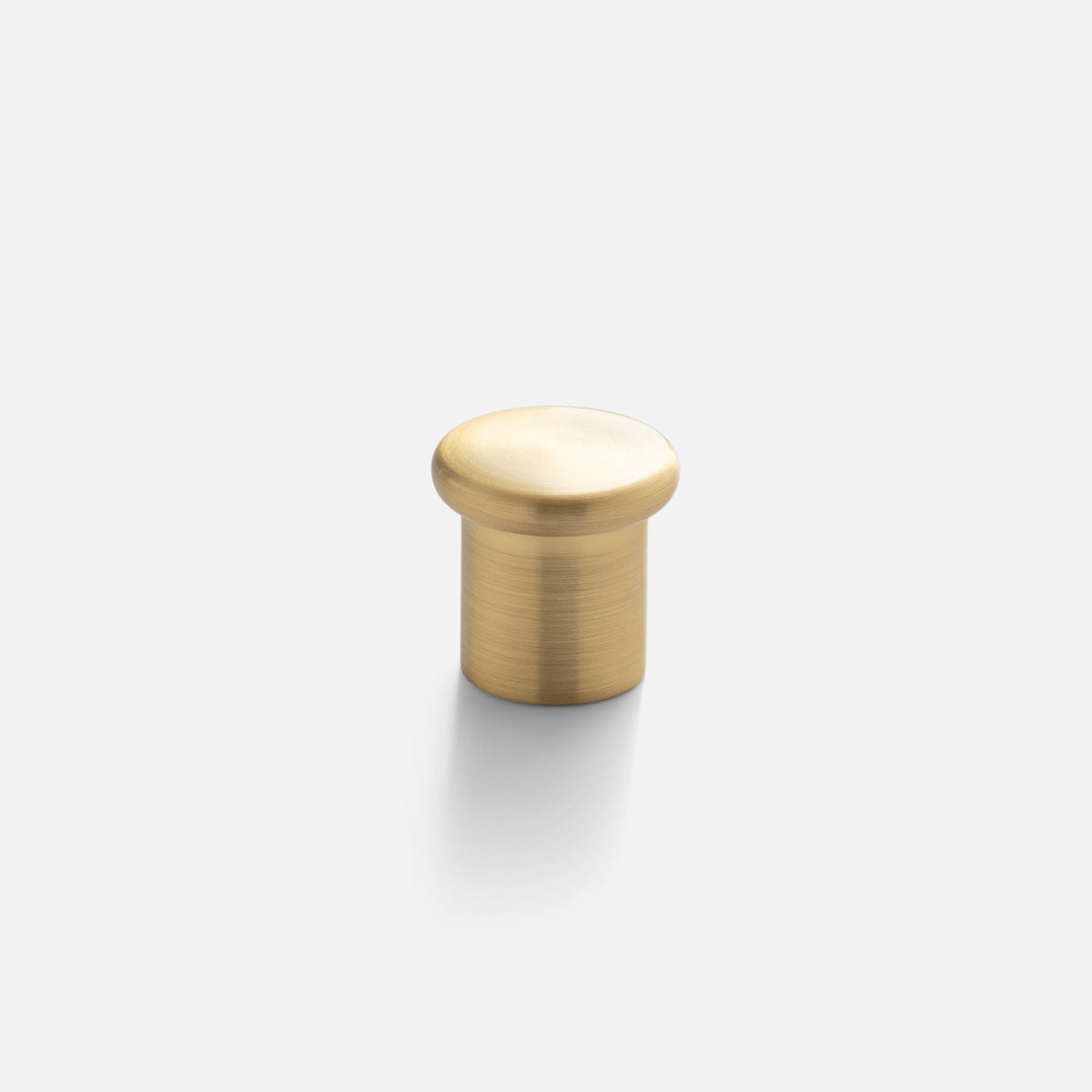 Front view of Remy Knob showcasing its soft curves and solid brass construction on a white background