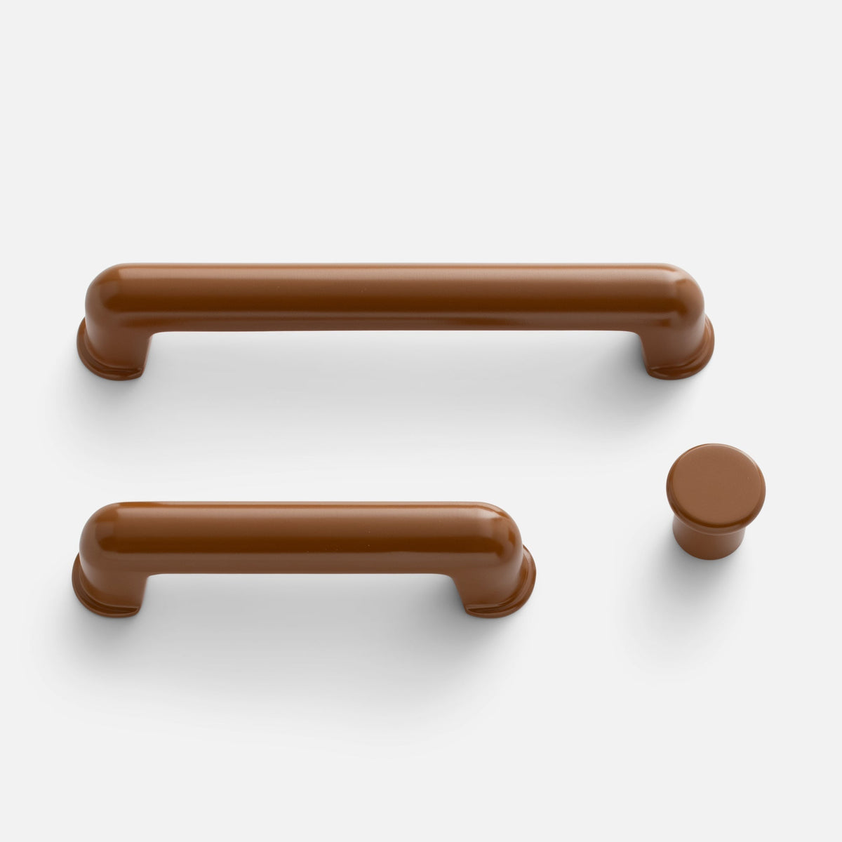 Top view of Remy Pull showcasing rounded brown bar pulls and matching knob with a white background