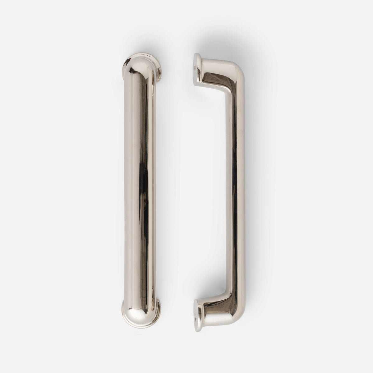 Close-up of Remy Pull showcasing its reflective metal finish, rounded rectangular handle, and mounting plates on a white background