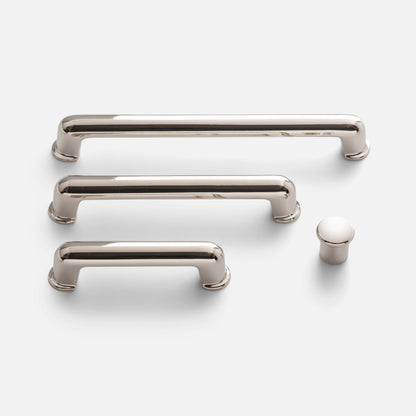 Front view of Remy Knob cabinet hardware showcasing soft curves and solid brass construction on a white background