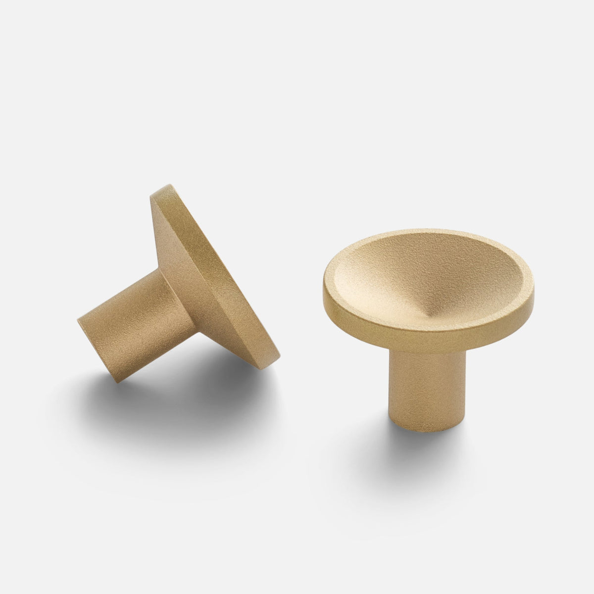 Angled views of the Rhone Cast Brass Knob showcasing its textured minimalist shape on a white background