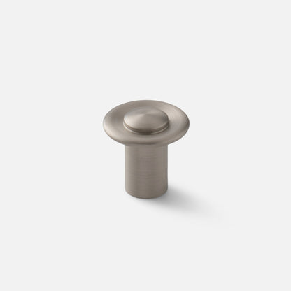 Angled view of Landon Knob showcasing its round raised center and circular base against a light background