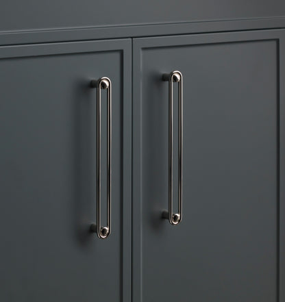 Close-up of two Landon Pull cabinet handles showcasing elongated rounded ends on dark cabinet doors