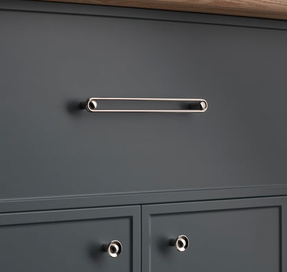 Front view of Landon Pull showcasing an elongated reflective bar mounted on a dark gray cabinet