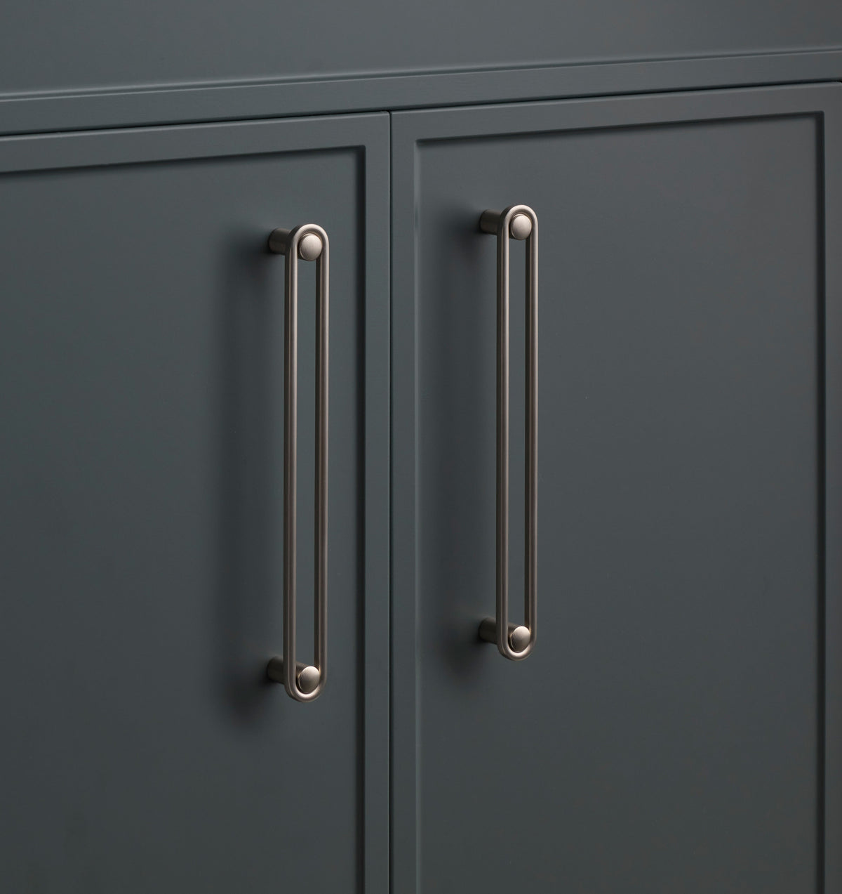 Close-up of the Landon Pull showcasing its elongated rounded design on dark cabinet doors