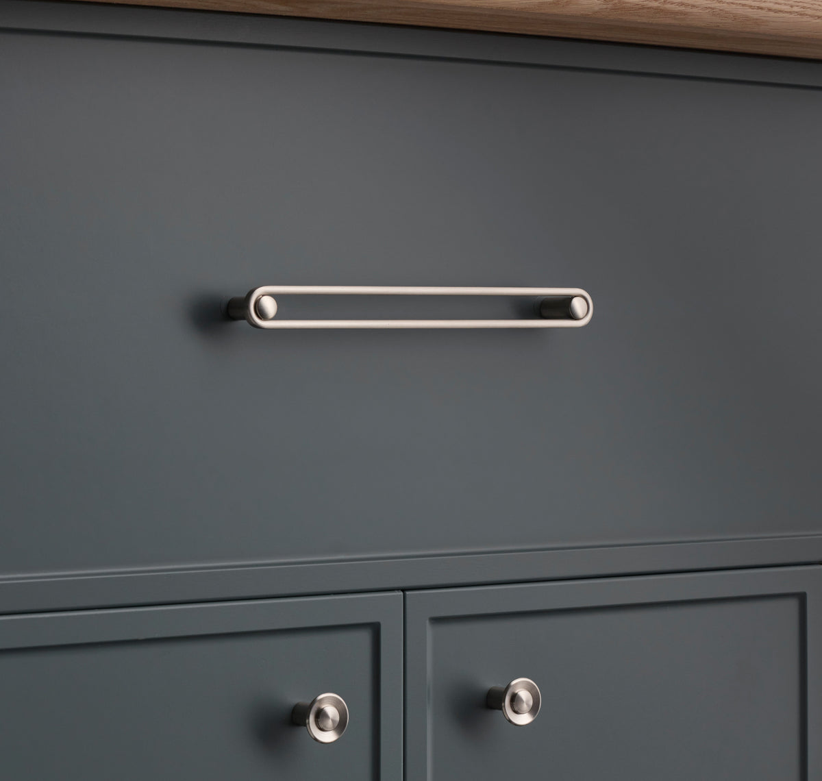 Front view of Landon Pull showcasing its elongated bar design on dark gray cabinetry