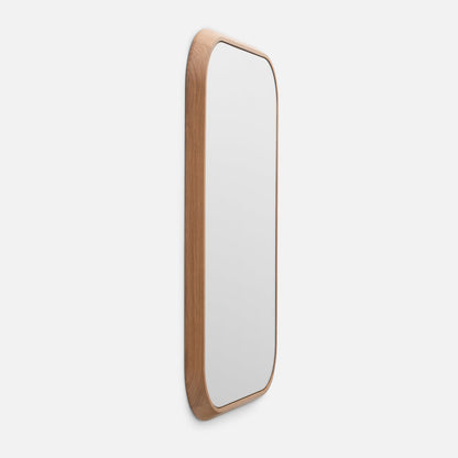 Angled side view of Oak Chamfered Mirror showing solid white oak chamfered frame and rounded top on a white background