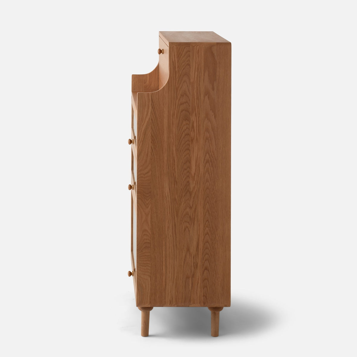 Side view of Peggy Cabinet showcasing wood-grain finish and rounded legs with a white background
