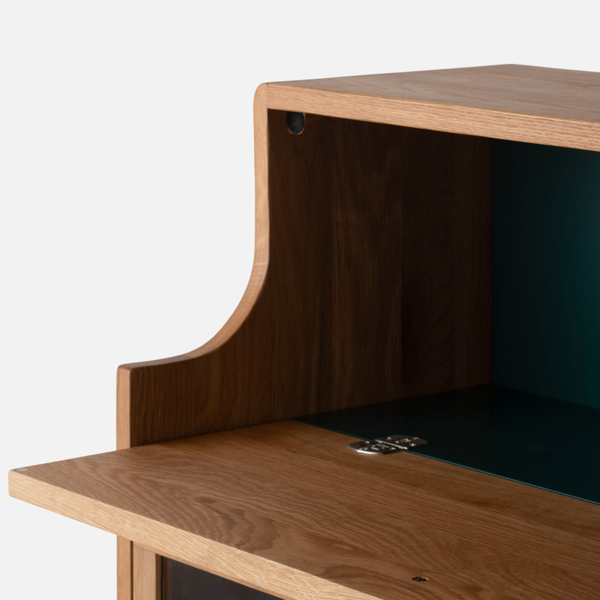 Close-up view of Peggy Cabinet showcasing its wood grain and curved side panel with a dark interior