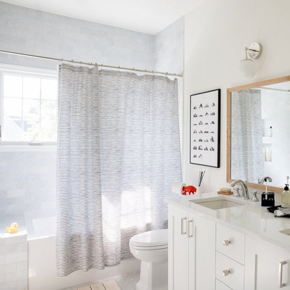 Edgecliff cabinet pulls featured on a white bathroom vanity in a bright bathroom