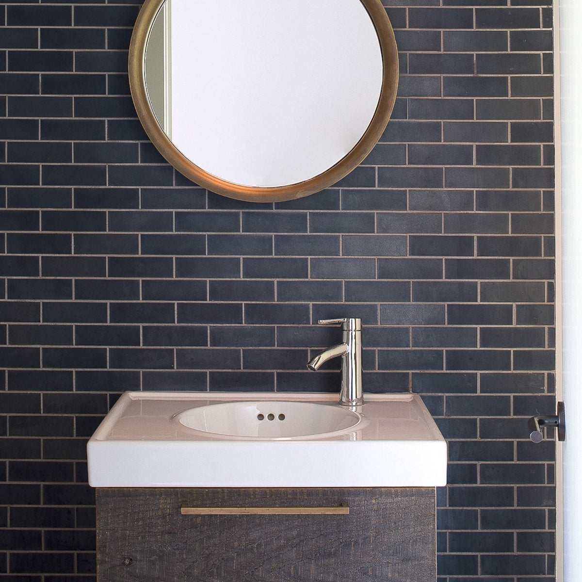 Edgecliff appliance pull mounted on a dark wood bathroom vanity beneath a white sink