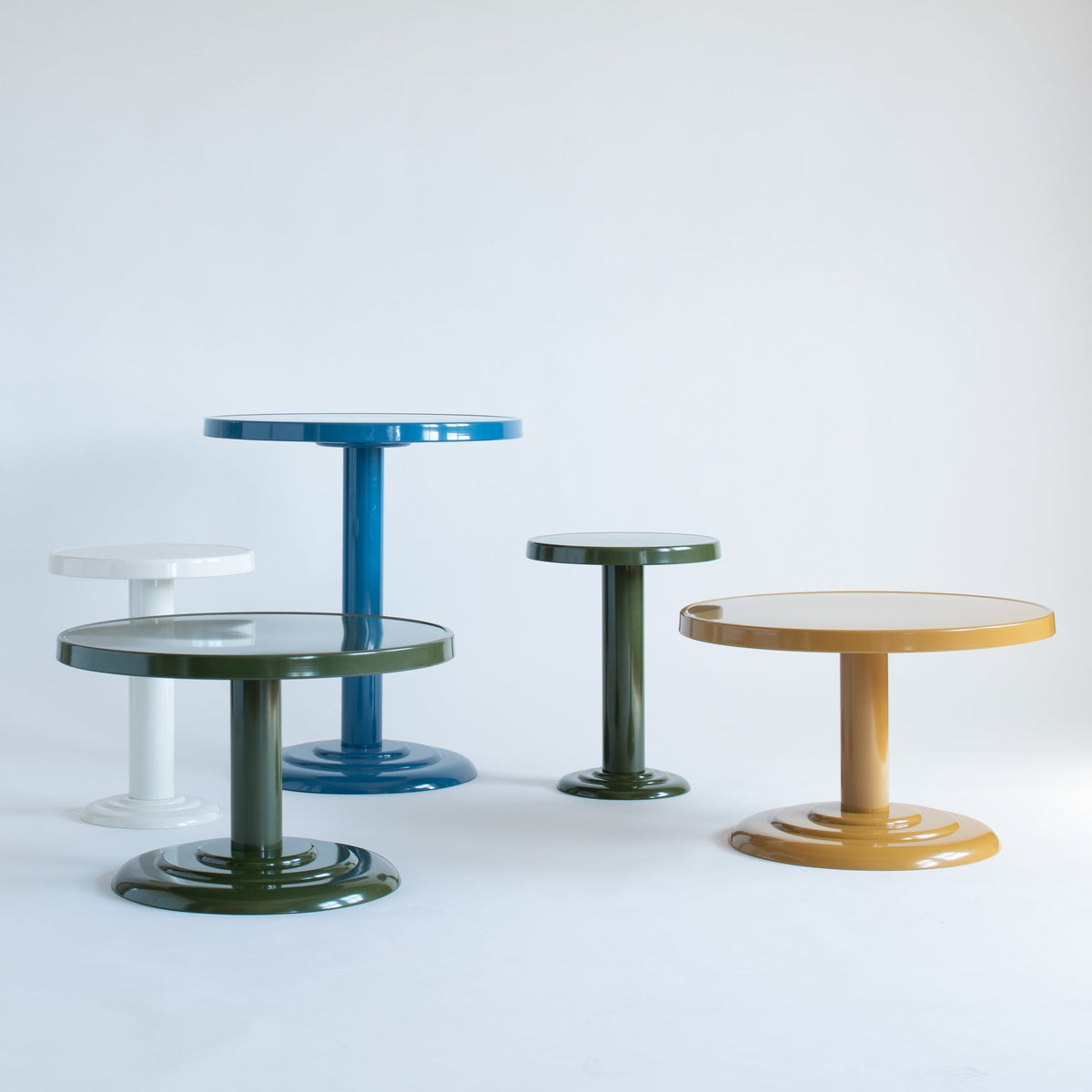 Front view of Owen Bistro Table showcasing its round powder-coated steel design in multiple colors against a light background