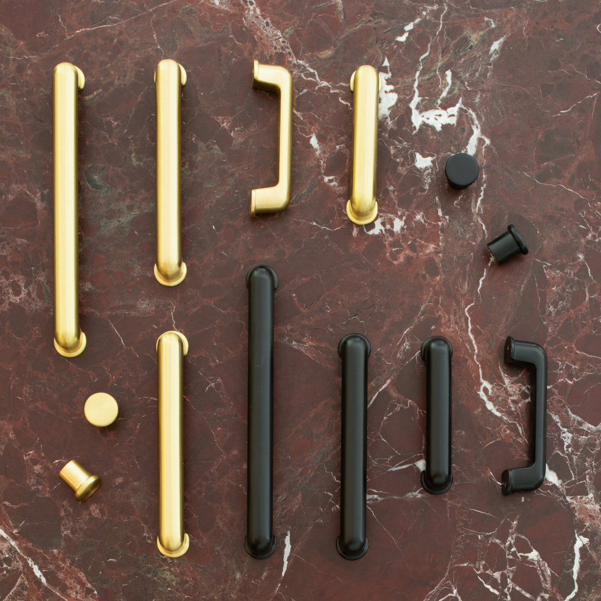 Overhead view of Remy Knob showcasing soft curves and solid brass on a red marble surface