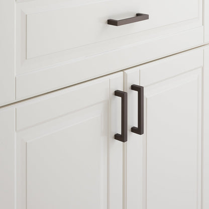 Close-up of Edgecliff Pull showcasing rectangular bar design with white paneled cabinetry