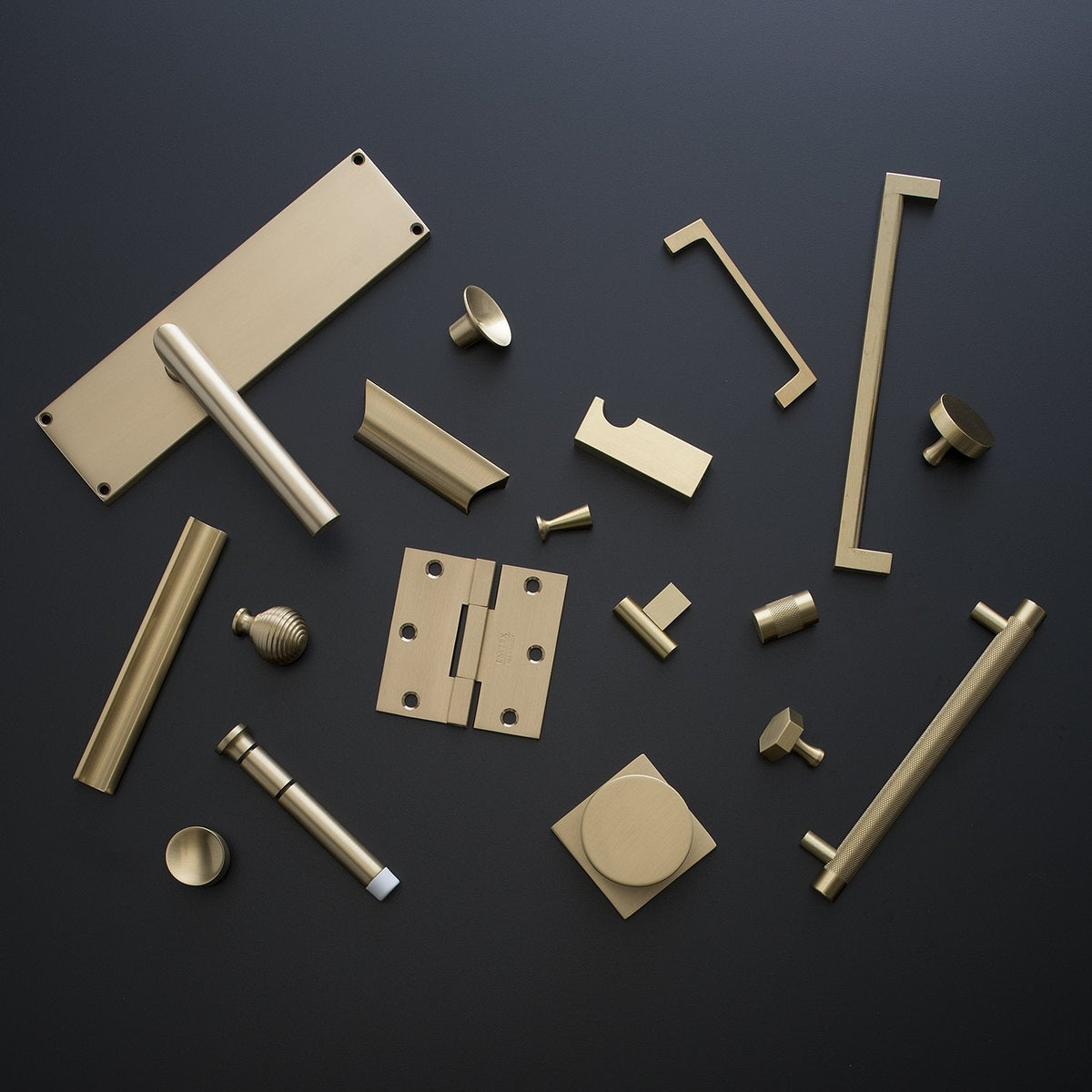 Top view of Edgecliff Pull showcasing its brass finish with coordinating hardware on a dark background