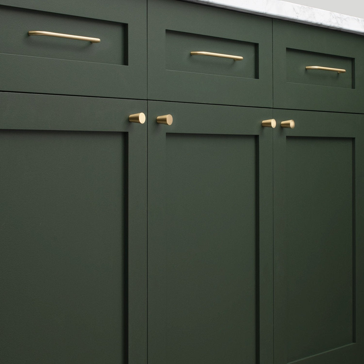 Close-up of Parker Pull hardware showcasing bar and knob pulls on dark green paneled cabinetry