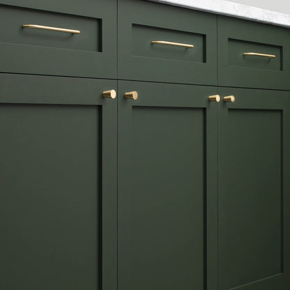Close-up of Parker Pull hardware showcasing bar and knob pulls on dark green paneled cabinetry
