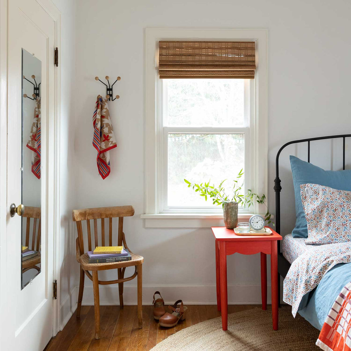 Mollie 6 Hook mounted beside a bedroom door holding scarves in a bright bedroom