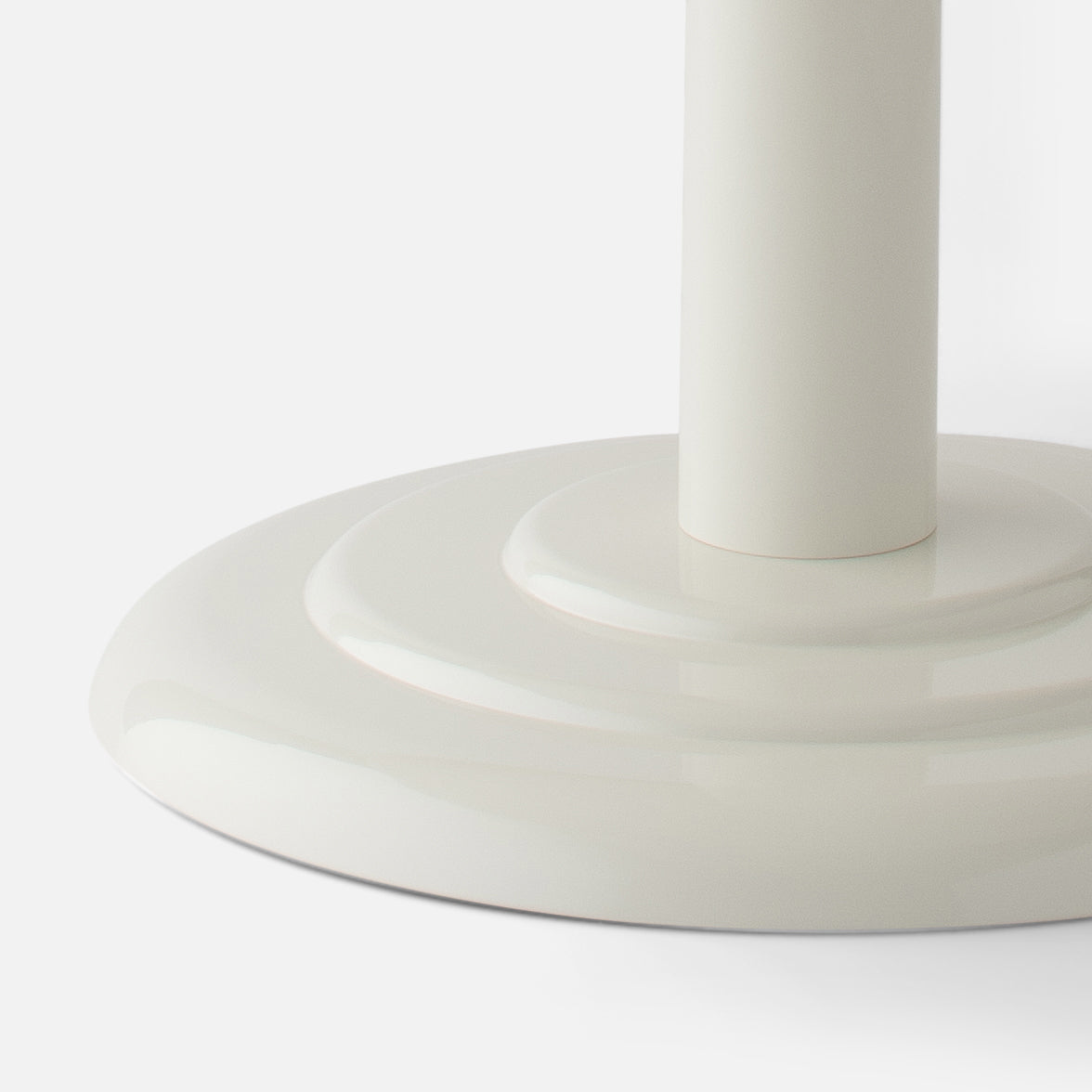 Close-up of Owen Side Table base showcasing stepped circular pedestal and shell white gloss finish on a white background